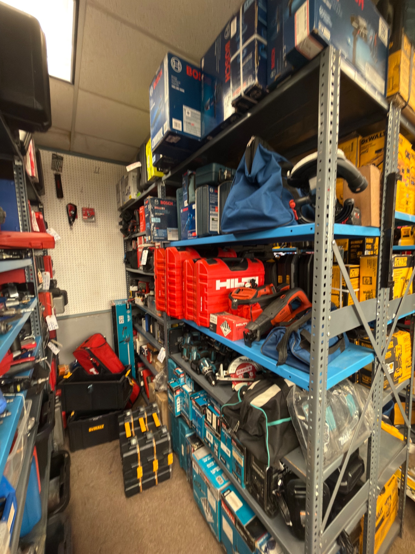 Shelves of Bosch, Hilti, and Makita power tools