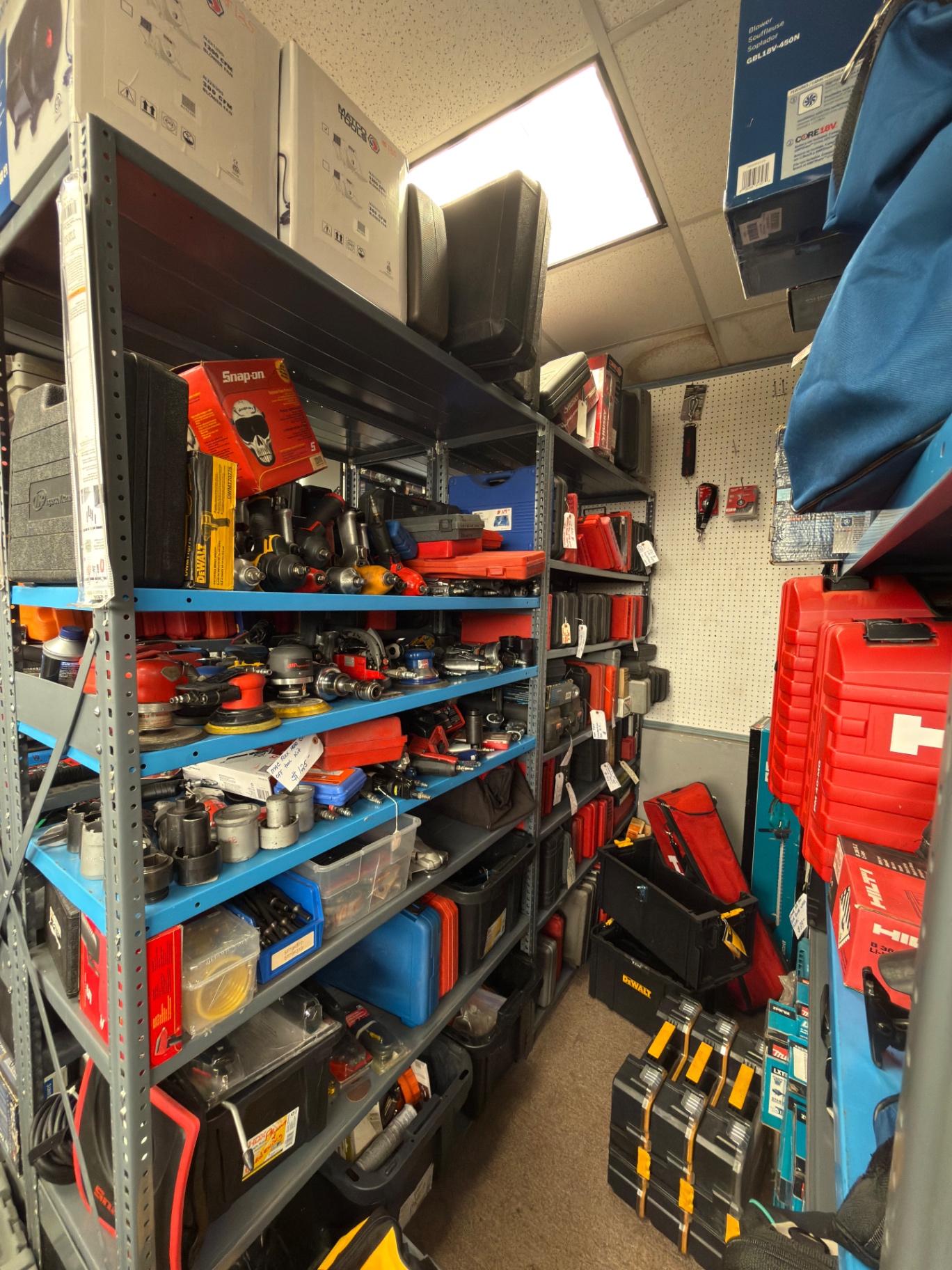 Back room shelves of Snap-on automotive tools and cases